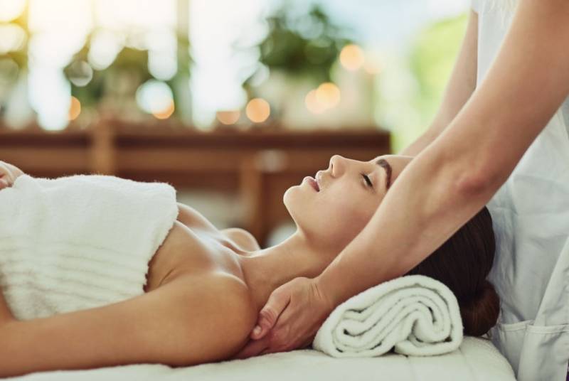 Shot of an attractive young woman getting massaged at a beauty spa